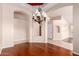 Dining room with hardwood floors, decorative chandelier, and archway to other rooms at 2230 E Whitten St, Chandler, AZ 85225
