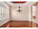 Dining room featuring hardwood floors, decorative chandelier, and large window at 2230 E Whitten St, Chandler, AZ 85225