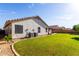 Well-maintained home exterior showcasing lush lawn and landscaped backyard at 2230 E Whitten St, Chandler, AZ 85225