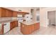 Spacious kitchen featuring an island, white appliances, and ample cabinet space at 2230 E Whitten St, Chandler, AZ 85225