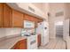 Well-lit kitchen with white appliances, cabinets, tile floors, and island at 2230 E Whitten St, Chandler, AZ 85225