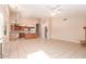 Spacious open floor plan with tile flooring, an island kitchen, and a stone fireplace at 2230 E Whitten St, Chandler, AZ 85225