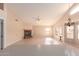 Expansive living room features a fireplace, ceiling fan, and tile flooring at 2230 E Whitten St, Chandler, AZ 85225