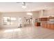 Bright living room with tile floors, fan, and windows overlooking backyard at 2230 E Whitten St, Chandler, AZ 85225