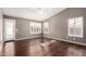 Main bedroom featuring hardwood floors, ceiling fan, and shuttered windows at 2230 E Whitten St, Chandler, AZ 85225