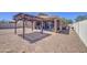 Desert landscaped backyard featuring a covered patio and pergola, perfect for outdoor living at 23781 W Mohave St, Buckeye, AZ 85326