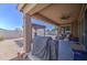 Covered patio with backyard view, including desert landscaping, pergola, and outdoor grill at 23781 W Mohave St, Buckeye, AZ 85326