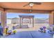 Covered patio view of a desert landscaped backyard featuring a pergola at 23781 W Mohave St, Buckeye, AZ 85326