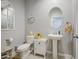 Charming powder room with pedestal sink, decorative mirror, and modern fixtures at 23781 W Mohave St, Buckeye, AZ 85326