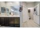 The bathroom features dual vanity, a large mirror and tiled floors at 23781 W Mohave St, Buckeye, AZ 85326