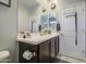 Bathroom view features a dark wood vanity, a toilet and a white door at 23781 W Mohave St, Buckeye, AZ 85326
