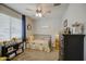 Comfortable bedroom with a ceiling fan, area rug, and a window with blinds at 23781 W Mohave St, Buckeye, AZ 85326