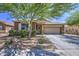 Charming single-story home featuring a well-manicured front yard and a two-car garage at 23781 W Mohave St, Buckeye, AZ 85326
