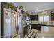 Well-lit kitchen featuring stainless steel appliances and dark wood cabinets for ample storage at 23781 W Mohave St, Buckeye, AZ 85326