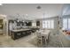 Open-concept kitchen and dining area featuring a large island with seating at 23781 W Mohave St, Buckeye, AZ 85326