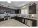 Modern kitchen with stainless steel appliances and dark wood cabinets at 23781 W Mohave St, Buckeye, AZ 85326