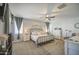 The main bedroom boasts a ceiling fan, dresser and plush carpet at 23781 W Mohave St, Buckeye, AZ 85326