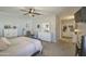 This spacious main bedroom features neutral walls, soft carpet and ceiling fan at 23781 W Mohave St, Buckeye, AZ 85326