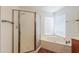 Bathroom with corner tub, glass shower, and bright natural light at 238 W Myrna Ln, Tempe, AZ 85284