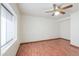 Neutral bedroom featuring wood-look floors, a ceiling fan, and a large window at 238 W Myrna Ln, Tempe, AZ 85284