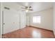 This bedroom features a ceiling fan, wood floors, closet with mirrored doors and natural light at 238 W Myrna Ln, Tempe, AZ 85284
