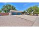 Charming single-story home with a three-car garage, a gravel front yard, and mature trees at 238 W Myrna Ln, Tempe, AZ 85284