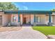 Covered front porch with stone pillars, a brick walkway, and an ornate wooden front door at 238 W Myrna Ln, Tempe, AZ 85284