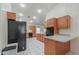 Spacious kitchen with white tile floors, wood cabinets, black appliances, and abundant counter space, ideal for cooking at 238 W Myrna Ln, Tempe, AZ 85284