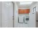 Convenient laundry room with appliances, storage cabinets, and a side entry door at 238 W Myrna Ln, Tempe, AZ 85284