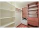 Bright walk-in closet with custom shelving and hardwood floors provides great storage at 238 W Myrna Ln, Tempe, AZ 85284