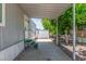 Exterior covered entry with charming, small, green entry stairs and gravel landscaping at 2650 W Union Hills Dr # 245, Phoenix, AZ 85027