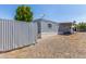Manufactured home featuring an exterior storage unit, car port, and gravel landscaping at 2650 W Union Hills Dr # 245, Phoenix, AZ 85027