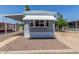 Charming mobile home featuring a cozy awning and well-maintained gravel landscaping at 2650 W Union Hills Dr # 245, Phoenix, AZ 85027