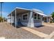 Manufactured home featuring a covered parking and attractive, low-maintenance gravel landscaping at 2650 W Union Hills Dr # 245, Phoenix, AZ 85027