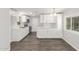 Bright kitchen featuring white cabinetry, modern appliances, and stylish wood flooring at 2650 W Union Hills Dr # 245, Phoenix, AZ 85027
