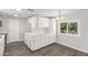 Kitchen featuring an island, white cabinets and wood-look floors at 2650 W Union Hills Dr # 245, Phoenix, AZ 85027
