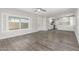 Open-concept living area with wood floors connecting to a well-lit kitchen at 2650 W Union Hills Dr # 245, Phoenix, AZ 85027