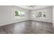 Bright living room featuring stylish wood flooring, large windows, and neutral wall color at 2650 W Union Hills Dr # 245, Phoenix, AZ 85027