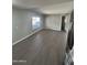 Open living area with sleek flooring, neutral paint, and a bright window, enhancing the spacious feel of the room at 300 S Val Vista Dr # 51, Mesa, AZ 85204