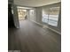 Bright living area featuring sleek flooring, large windows, and access to a covered parking, creating an inviting and airy atmosphere at 300 S Val Vista Dr # 51, Mesa, AZ 85204