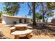 Large backyard shows an outdoor dining space with an umbrella and lots of room to relax at 3021 E Windrose Dr, Phoenix, AZ 85032