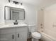 Well-lit bathroom features modern vanity, black hardware and shower over tub combo at 3021 E Windrose Dr, Phoenix, AZ 85032