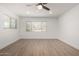 Bright and airy bedroom with wood-look floors, ceiling fan and lots of natural light at 3021 E Windrose Dr, Phoenix, AZ 85032