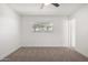 Clean bedroom featuring neutral carpet, a modern ceiling fan, and natural light at 3021 E Windrose Dr, Phoenix, AZ 85032
