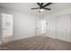 Spacious bedroom with neutral walls, closet, new carpet and a modern ceiling fan at 3021 E Windrose Dr, Phoenix, AZ 85032