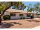 Attractive single-story home with desert landscaping, shrubs and mature trees in the front yard at 3021 E Windrose Dr, Phoenix, AZ 85032