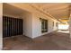 Covered patio with access to the house via sliding glass doors and entry to carport through a dark metal gate at 3021 E Windrose Dr, Phoenix, AZ 85032