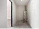 Unfinished room features water heater and access to additional rooms at 3021 E Windrose Dr, Phoenix, AZ 85032