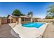Charming backyard with a refreshing pool, concrete patio, and ample space for outdoor enjoyment at 308 W Oraibi Dr, Phoenix, AZ 85027