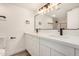 Bright bathroom with double sinks, white cabinets, and a large mirror with modern lighting at 308 W Oraibi Dr, Phoenix, AZ 85027